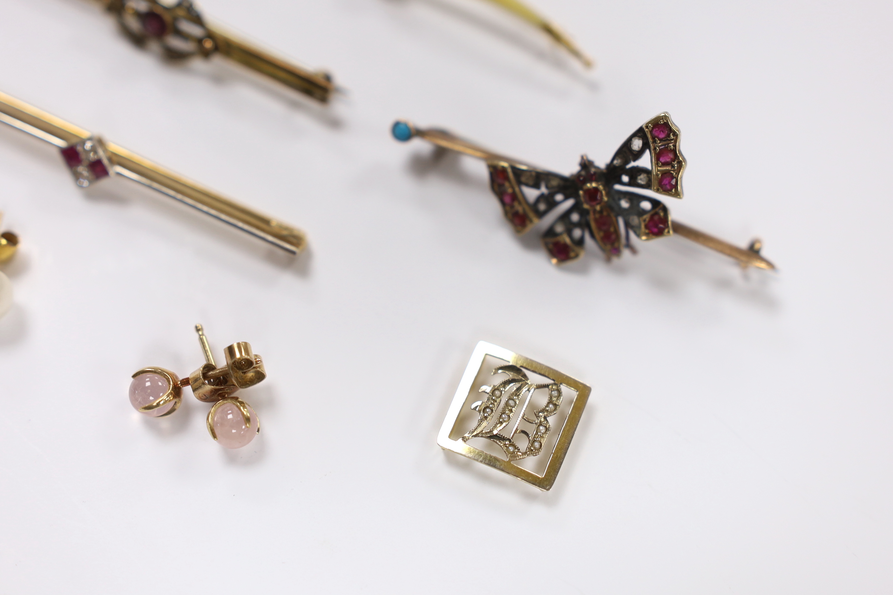 Four assorted yellow metal and gem set bar brooches, including a ruby and diamond four stone set, 56mm and a Victorian yellow metal, rose cut diamond and gem set butterfly bar brooch, together with two pairs of ear studs